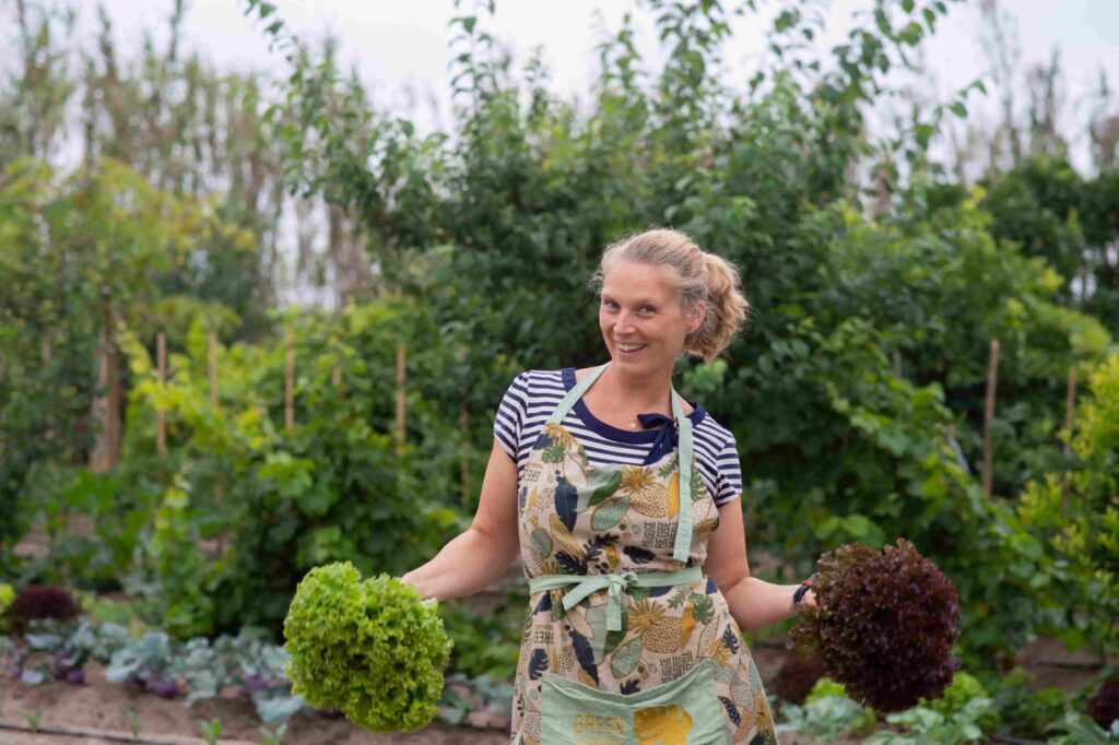 Ali from 4elements yoga retreat portugal in the garden with lettuce